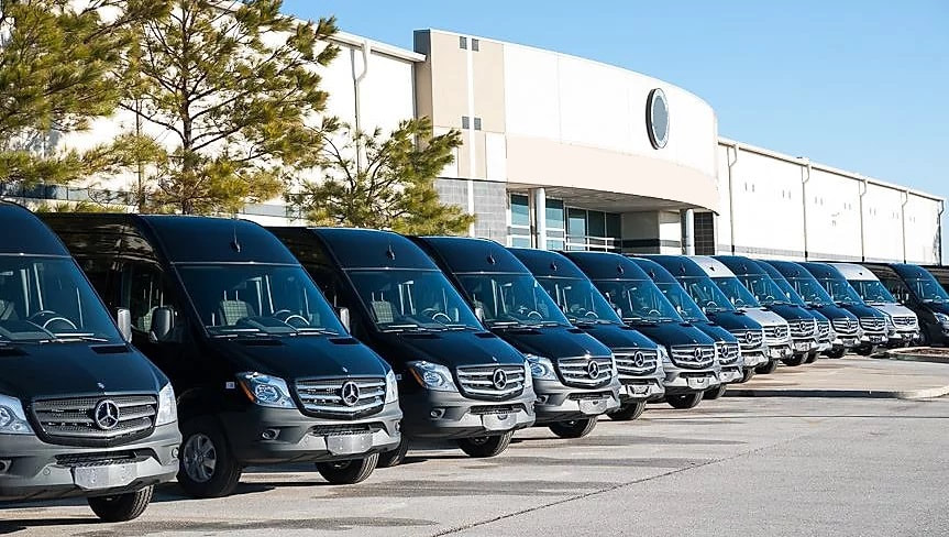 A row of luxury Sprinter vans